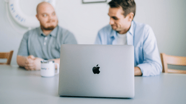 Coworkers at a table with a laptop