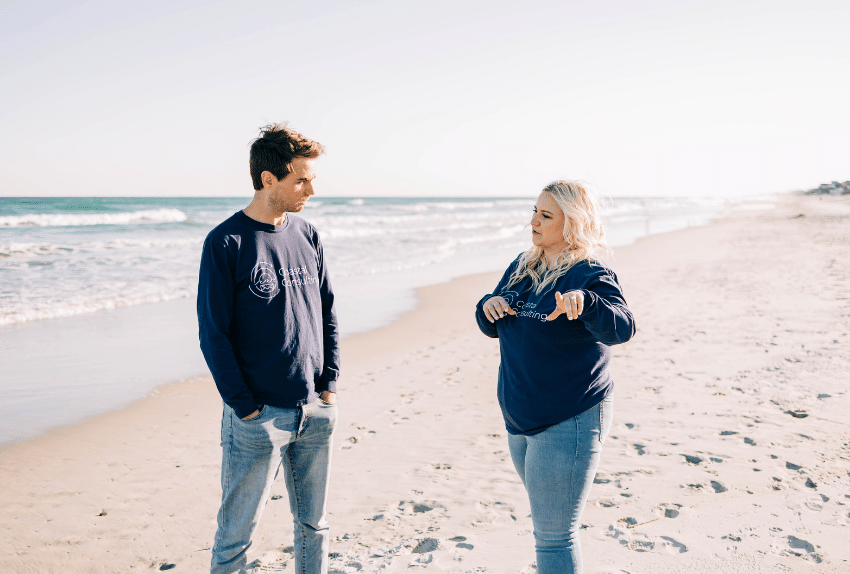 Coworkers talking on the beach