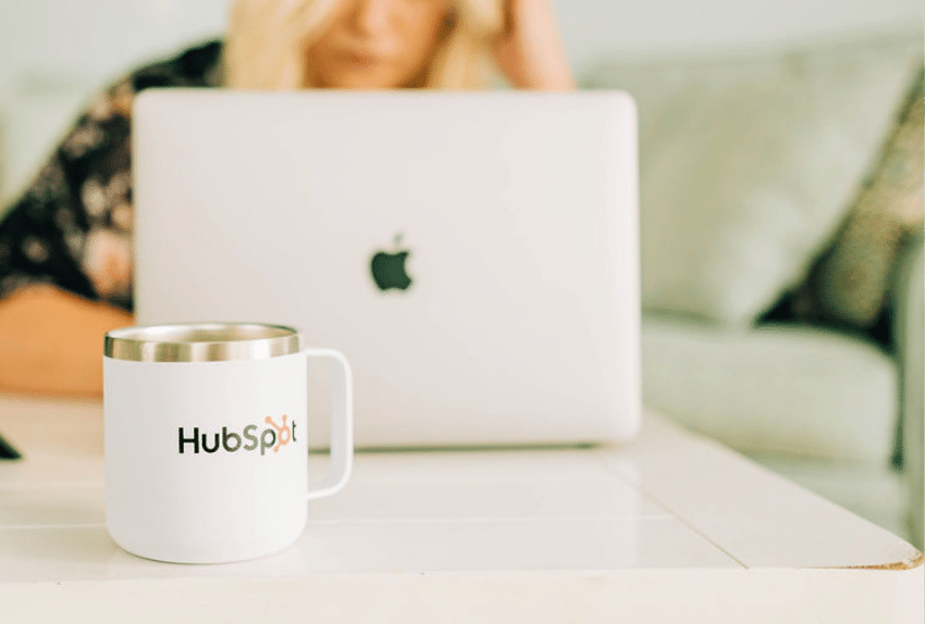Woman with laptop and HubSpot mug