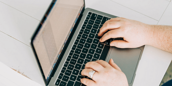 woman typing on laptop